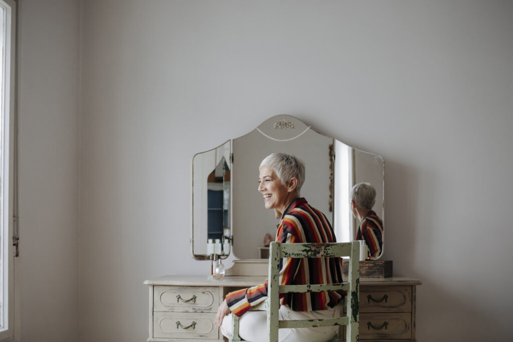 lady with white hair sitting at dressing table