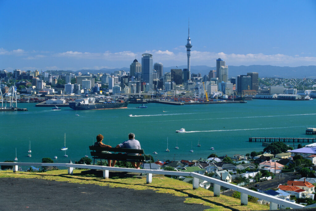 Couple looking out over downtown Auckland skyline and harbour.
