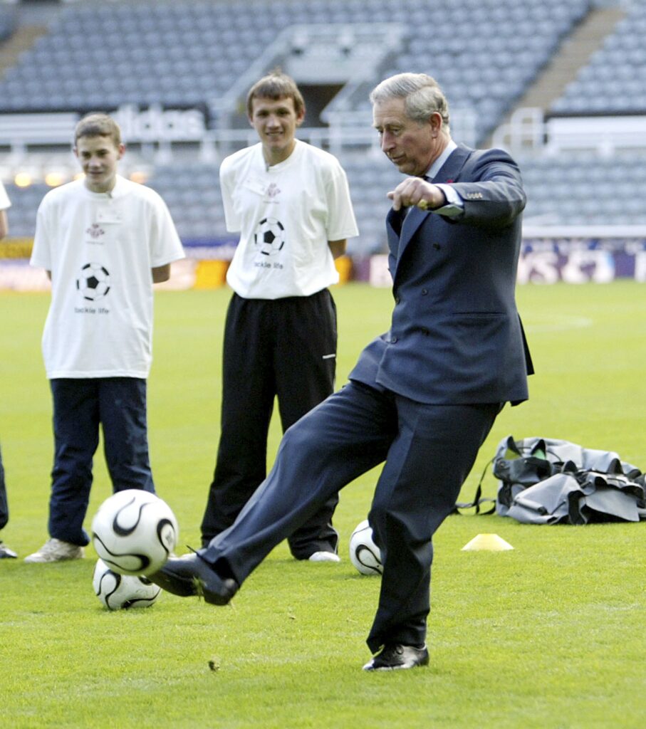 King Charles plays football during a visit to St James' park on November 8, 2006 in Newcastle-upon-Tyne, England.