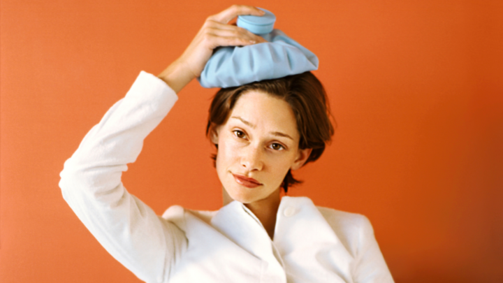 woman holding ice pack to her head