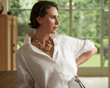 Woman in white shirt and gold necklace