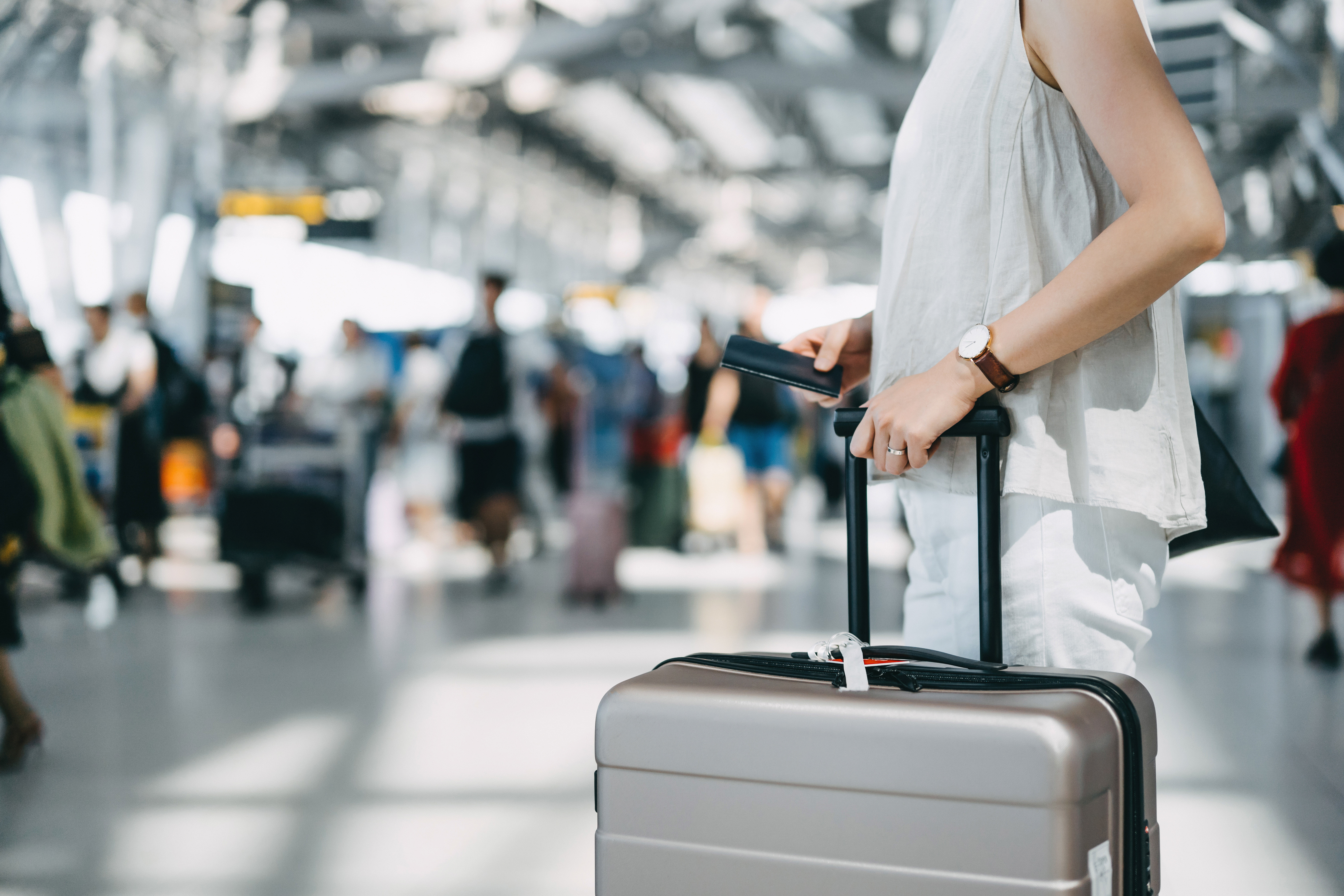 woman at airport with luggae - black friday flight sales