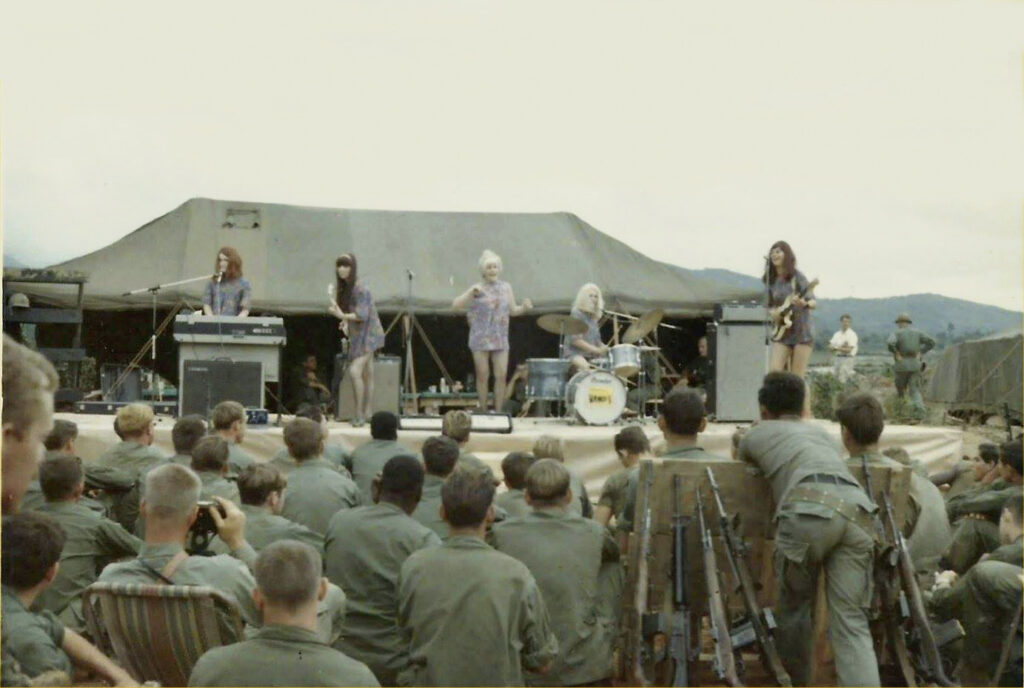 A group of Australian entertainers on stage performing for soldiers during the Vietnam war. 