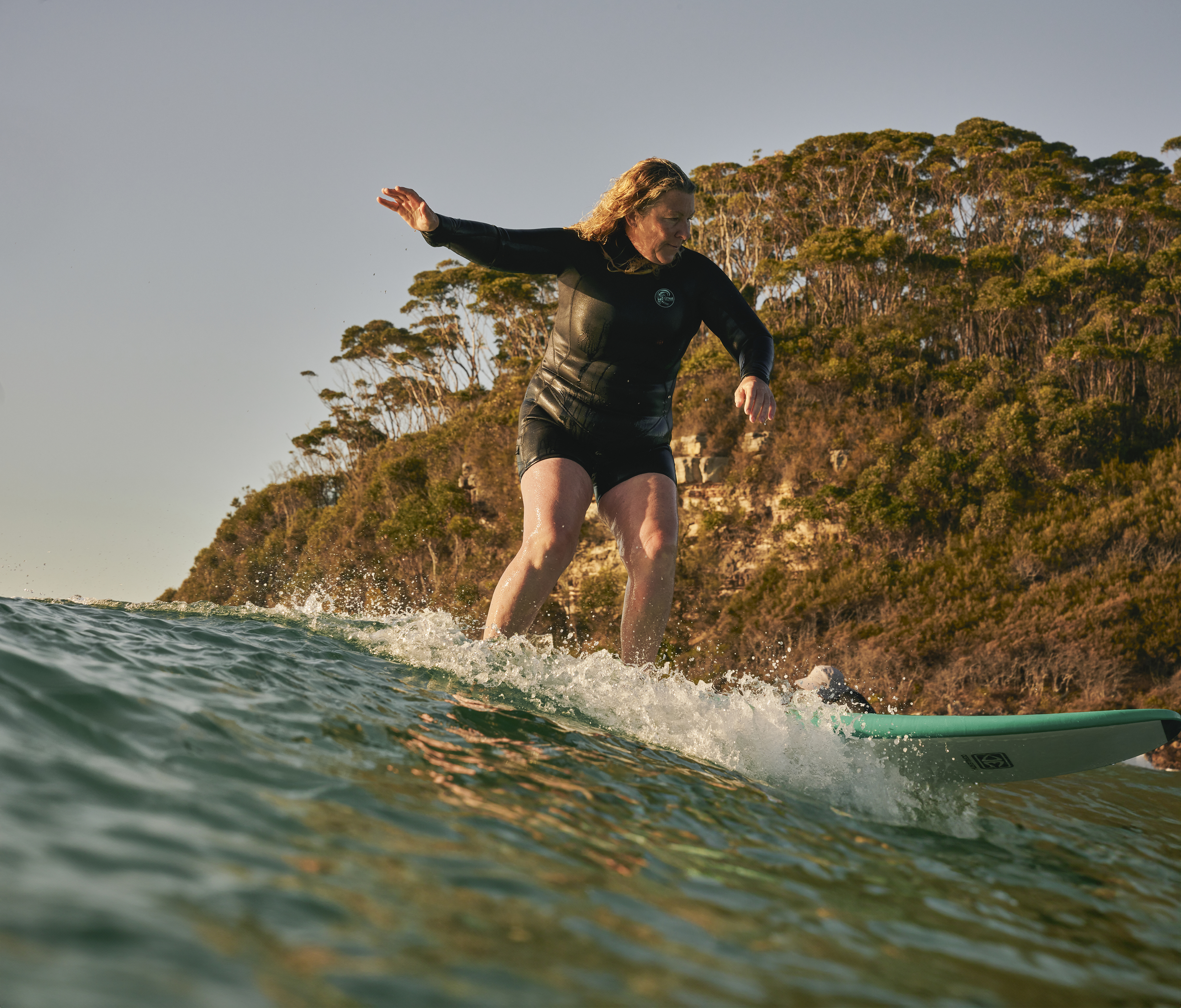 Australian female surfer Kirra Dowling riding on her surfboard. 