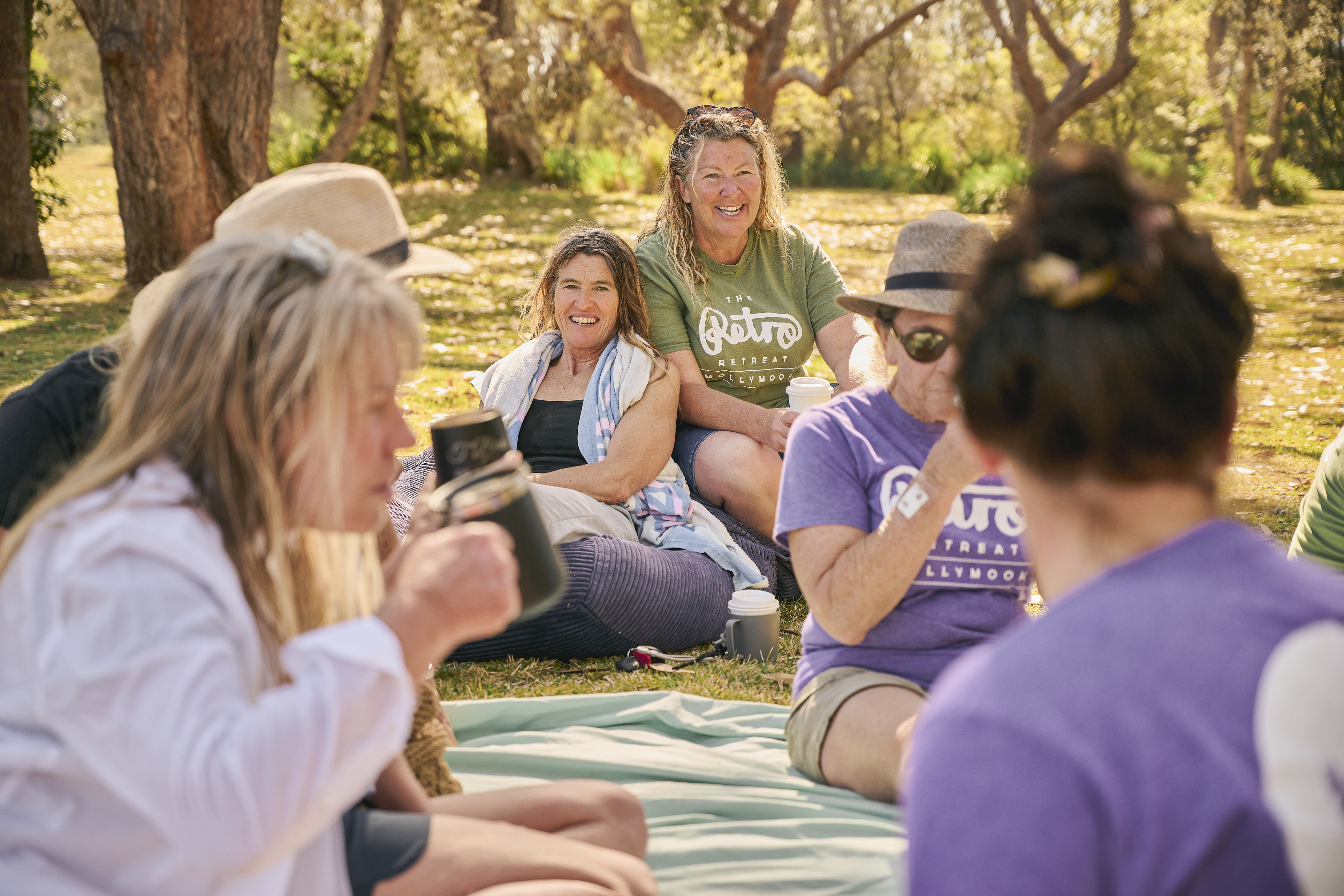 Australian female surfers gathered around at a retreat. 