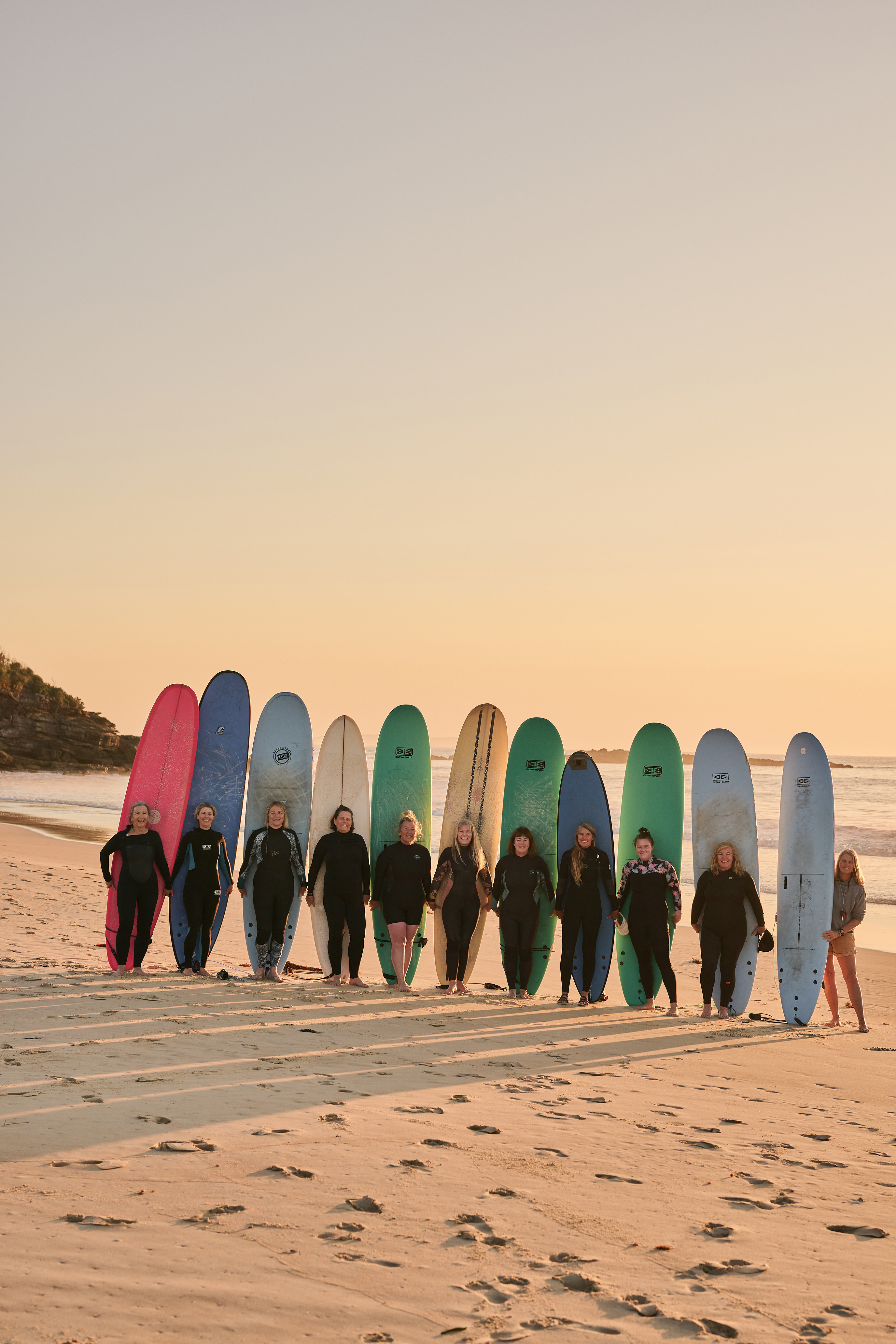 Australian female surfers on the beach with their surfboards. 