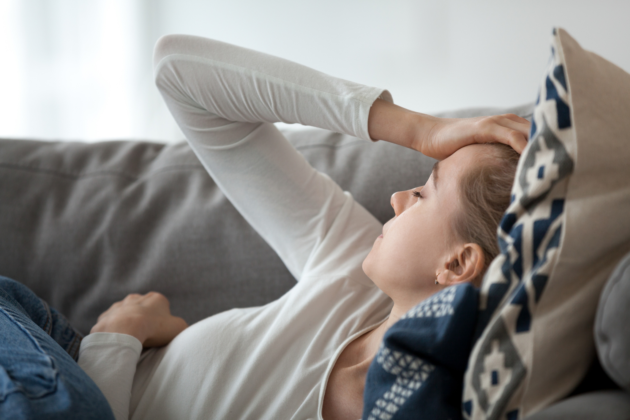 Woman in pain on lounge